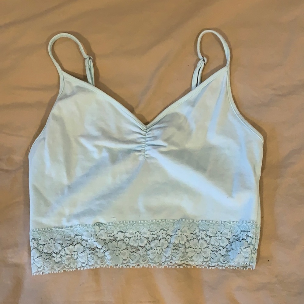 Light blue cropped tank top with mesh on bottle